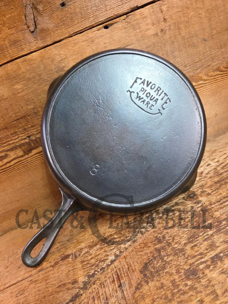 1920βs Favorite Piqua Ware #8 Cast Iron Skillet with Heat Ring and Smiley Logo Skillet