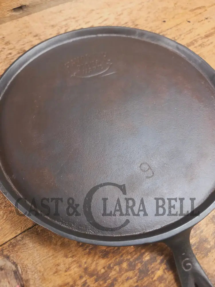 1920’s Favorite Piqua Ware #9 Round Cast Iron Griddle with Smiley Logo and Ghost mark block logo. Griddle
