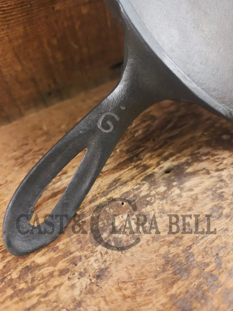 1920’s Favorite Piqua Ware #9 Round Cast Iron Griddle with Smiley Logo and Ghost mark block logo. Griddle
