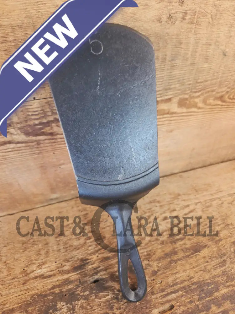 Custom made #5 Lodge Cast Iron Skillet Spatula w RAISED B. Reclaimed from a early to mid 1900’s single notch Lodge