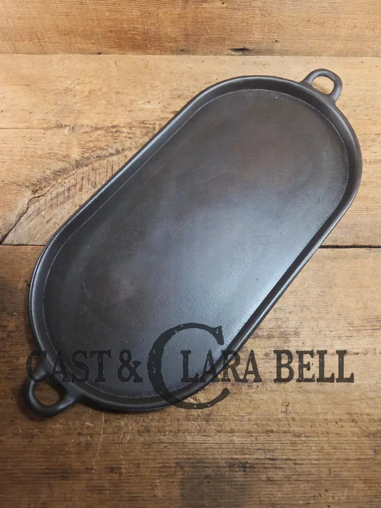Early 1900’s (Lodge?) #7 cast iron long pan with foot nubs. Perfect for two people or quick meals. VERY cool griddle to