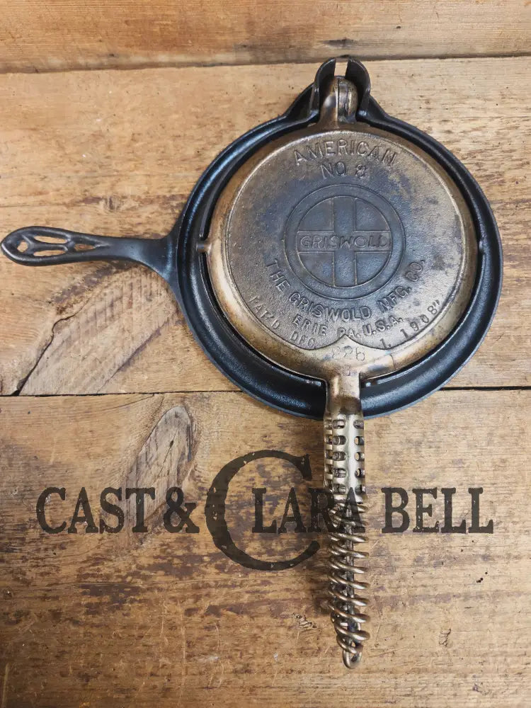 For the eclectic enthusiast!! 1920βs Griswold #8 Waffle Iron 885/886 with Matching Low Base 975. Plated paddles Black