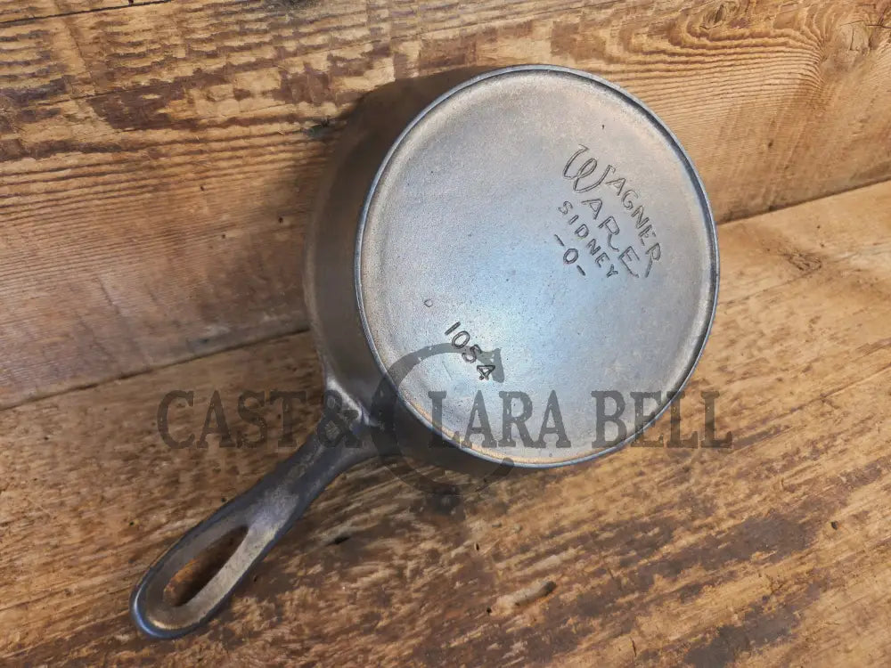 HTF! 1924 Wagner Ware #4 Cast Iron Skillet with Heat Ring 1054. Plating outside black iron inside. Beautiful patina!