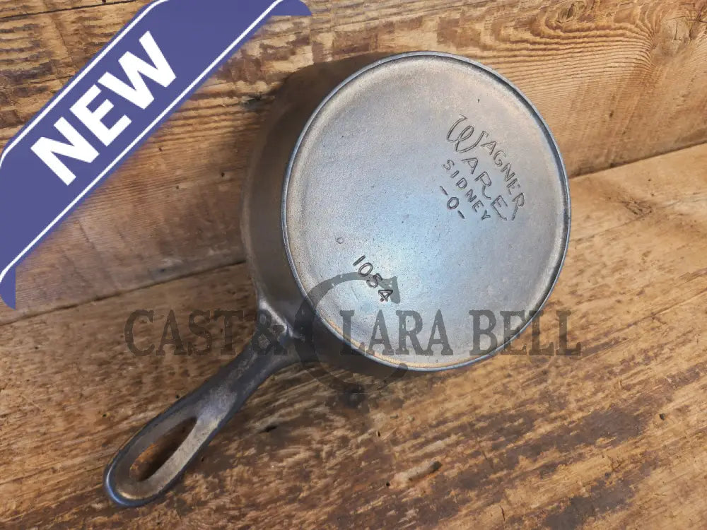 HTF! 1924 Wagner Ware #4 Cast Iron Skillet with Heat Ring 1054. Plating outside black iron inside. Beautiful patina!