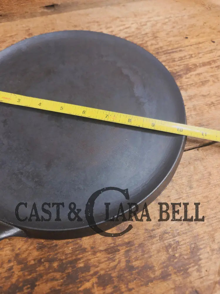 1920’s Favorite Piqua Ware #9 Round Cast Iron Griddle with Smiley Logo and Ghost mark block logo. Griddle