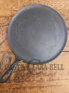1920’s Favorite Piqua Ware #9 Round Cast Iron Griddle with Smiley Logo and Ghost mark block logo. Griddle