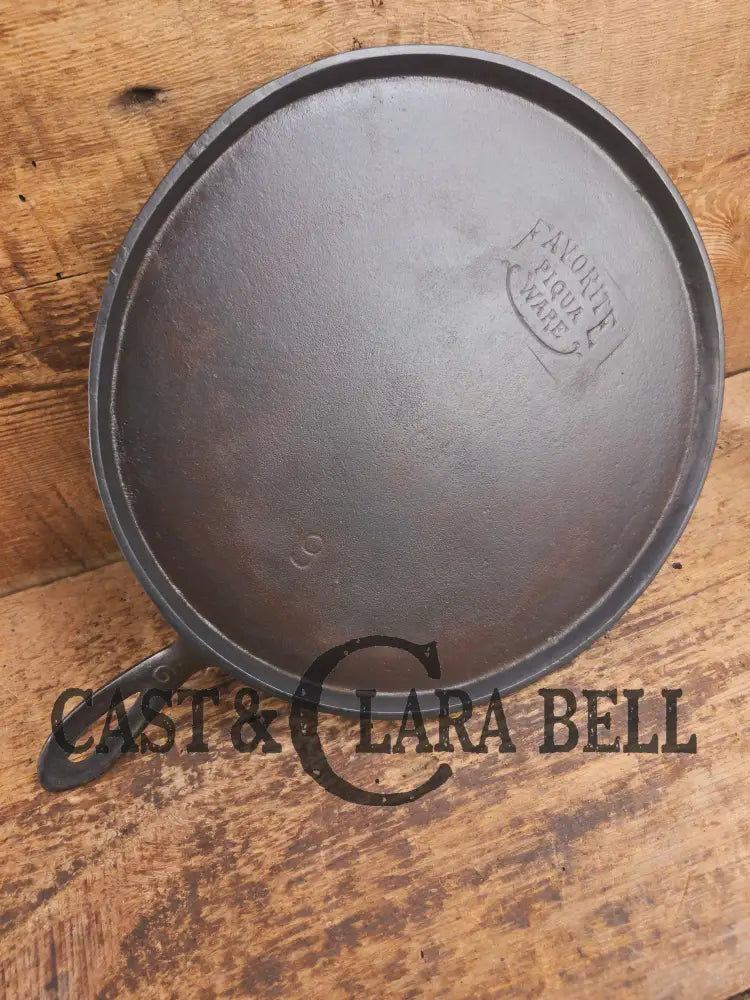 1920’s Favorite Piqua Ware #9 Round Cast Iron Griddle with Smiley Logo and Ghost mark block logo. Griddle