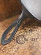 1920’s Favorite Piqua Ware #9 Round Cast Iron Griddle with Smiley Logo and Ghost mark block logo. Griddle