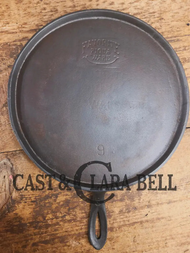 1920’s Favorite Piqua Ware #9 Round Cast Iron Griddle with Smiley Logo and Ghost mark block logo. Griddle