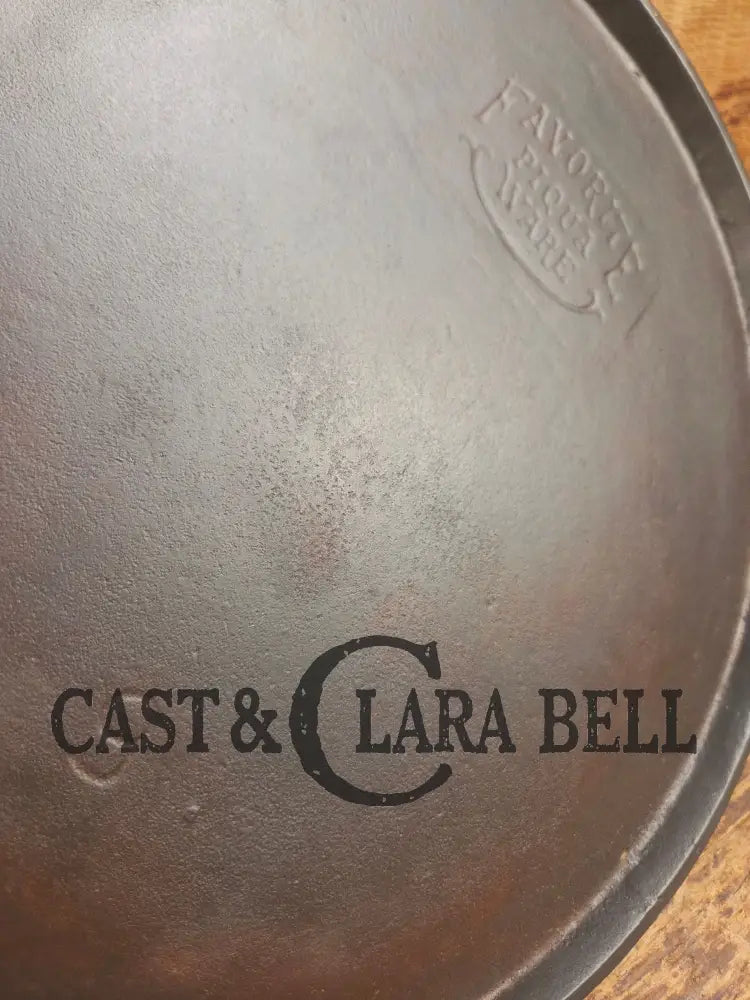 1920’s Favorite Piqua Ware #9 Round Cast Iron Griddle with Smiley Logo and Ghost mark block logo. Griddle