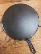 Awesome and tough to find! Scarce smooth bottom #12 Vollrath cast iron skillet. This is a conversation starter! Skillet