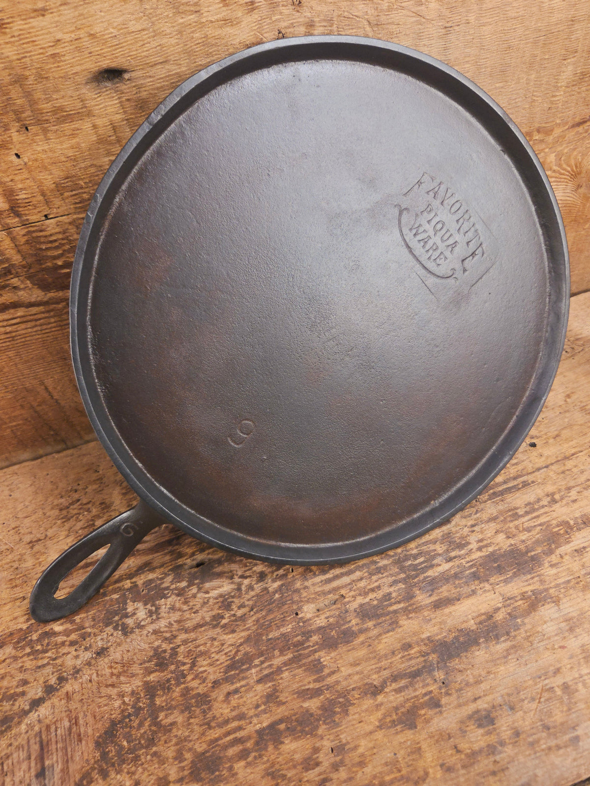 1920’s Favorite Piqua Ware #9 Round Cast Iron Griddle with Smiley Logo and Ghost mark block logo. Griddle