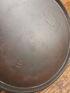 1920’s Favorite Piqua Ware #9 Round Cast Iron Griddle with Smiley Logo and Ghost mark block logo. Griddle