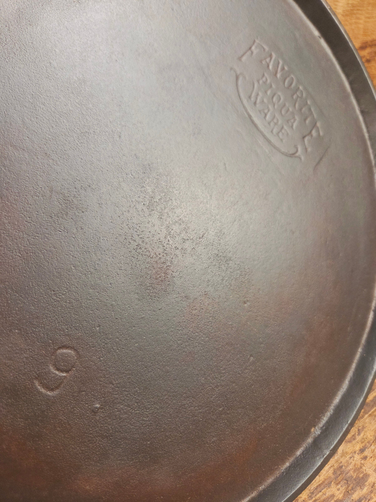 1920’s Favorite Piqua Ware #9 Round Cast Iron Griddle with Smiley Logo and Ghost mark block logo. Griddle