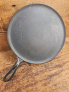 1920’s Favorite Piqua Ware #9 Round Cast Iron Griddle with Smiley Logo and Ghost mark block logo. Griddle