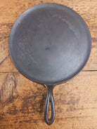1920’s Favorite Piqua Ware #9 Round Cast Iron Griddle with Smiley Logo and Ghost mark block logo. Griddle