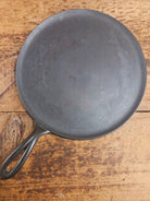 1920’s Favorite Piqua Ware #9 Round Cast Iron Griddle with Smiley Logo and Ghost mark block logo. Griddle