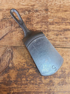 Custom made #5 Lodge Cast Iron Skillet Spatula w RAISED B. Reclaimed from a early to mid 1900’s single notch Lodge