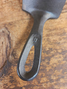 Custom made #5 Lodge Cast Iron Skillet Spatula w RAISED B. Reclaimed from a early to mid 1900’s single notch Lodge