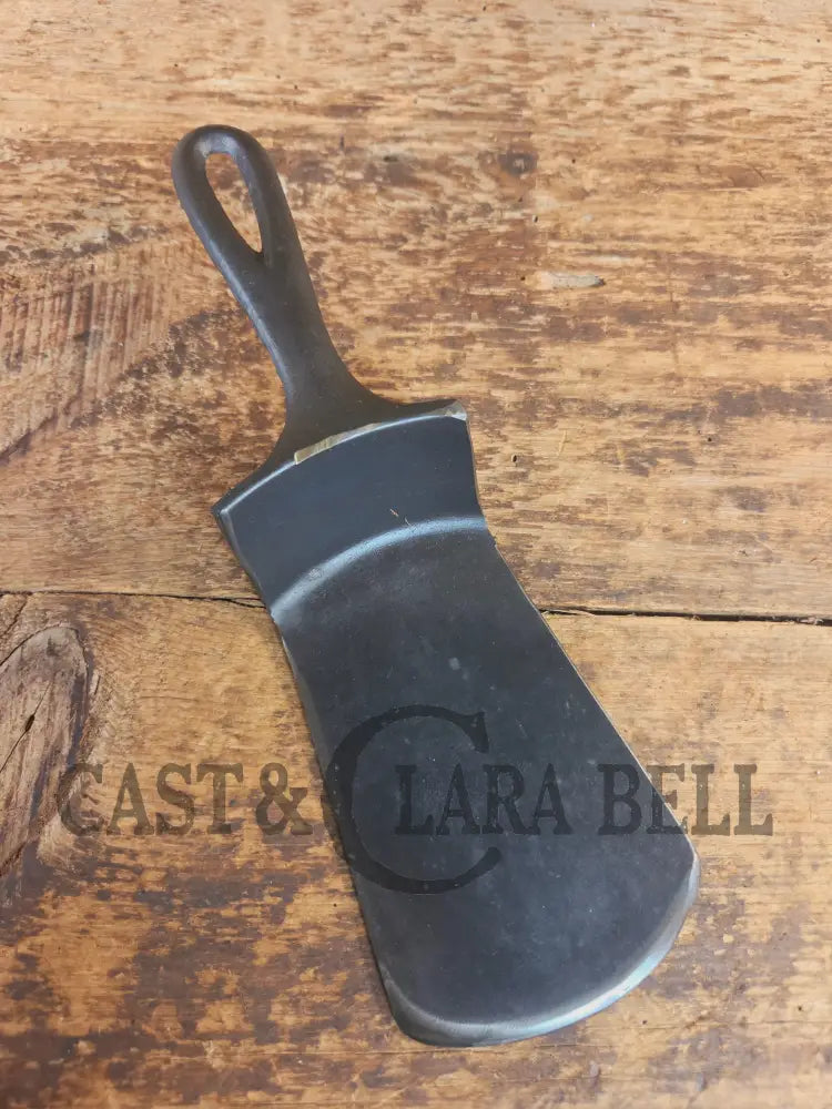 Custom made #5 Lodge Cast Iron Skillet Spatula w RAISED B. Reclaimed from a early to mid 1900’s single notch Lodge