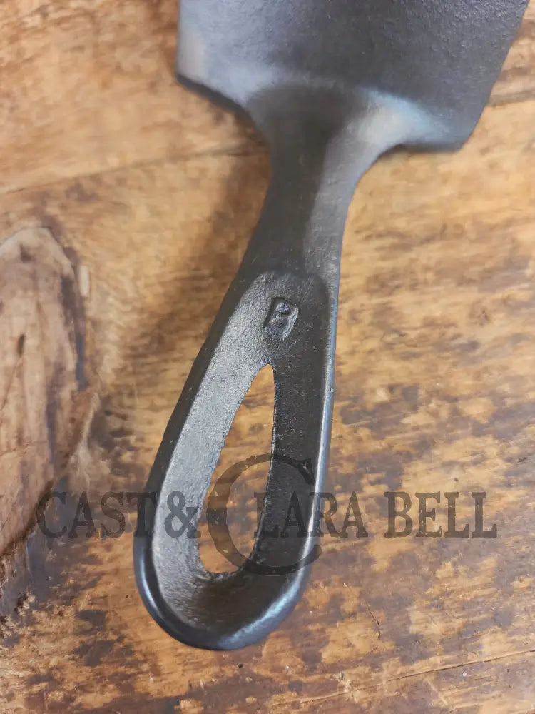 Custom made #5 Lodge Cast Iron Skillet Spatula w RAISED B. Reclaimed from a early to mid 1900’s single notch Lodge
