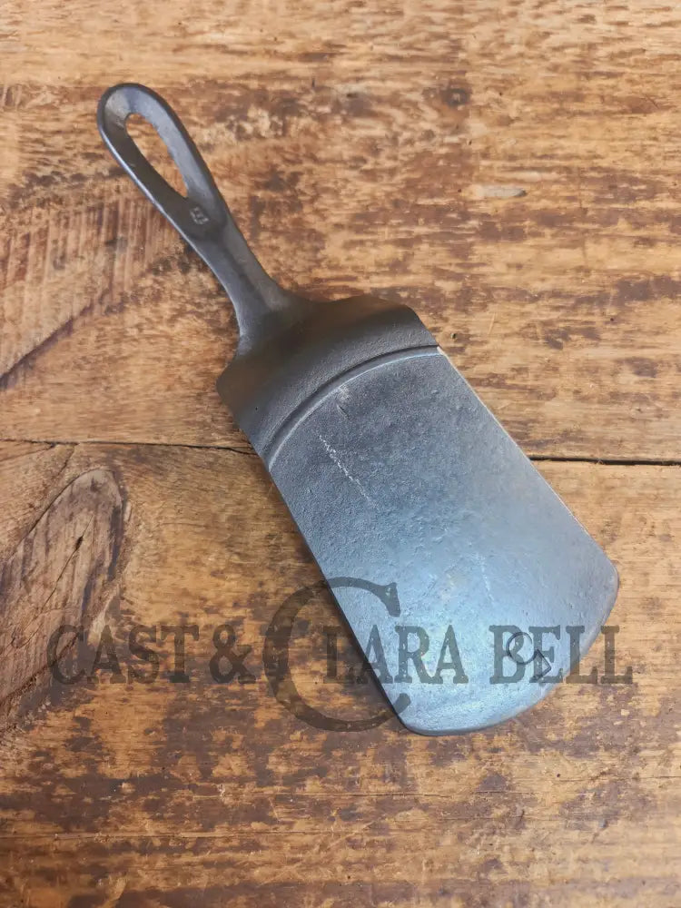 Custom made #5 Lodge Cast Iron Skillet Spatula w RAISED B. Reclaimed from a early to mid 1900’s single notch Lodge