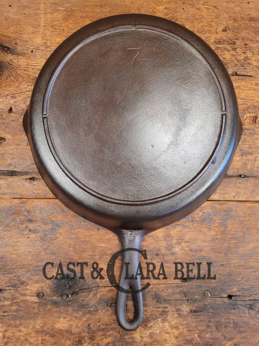 https://castandclarabell.com/cdn/shop/files/priced-to-sell-mid-1900s-lodge-7-skillet-with-3-notch-heat-ring-restored-and-ready-use-700.webp?v=1704233734&width=533