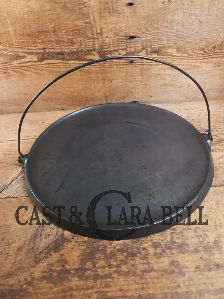 Spectacular piece! 1910’s #742 Griswold No. 14 Round Griddle w/ Bail and Slant Logo. The largest made of its kind and
